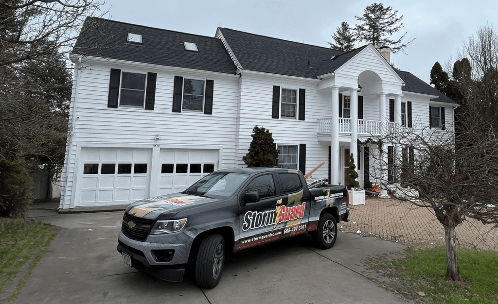 Storm Guard Car infront of  Residential Property