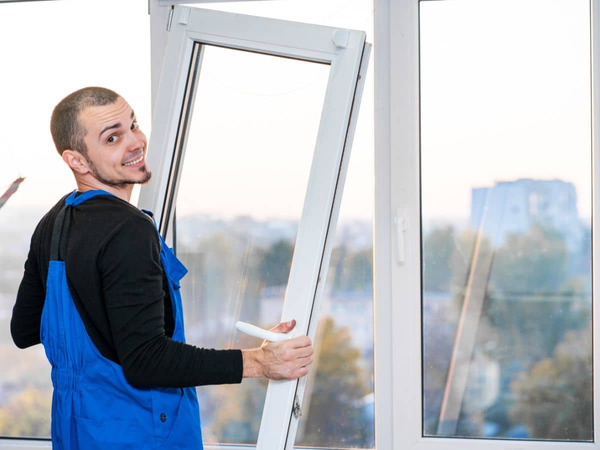 A construction worker installing a window in Nashville