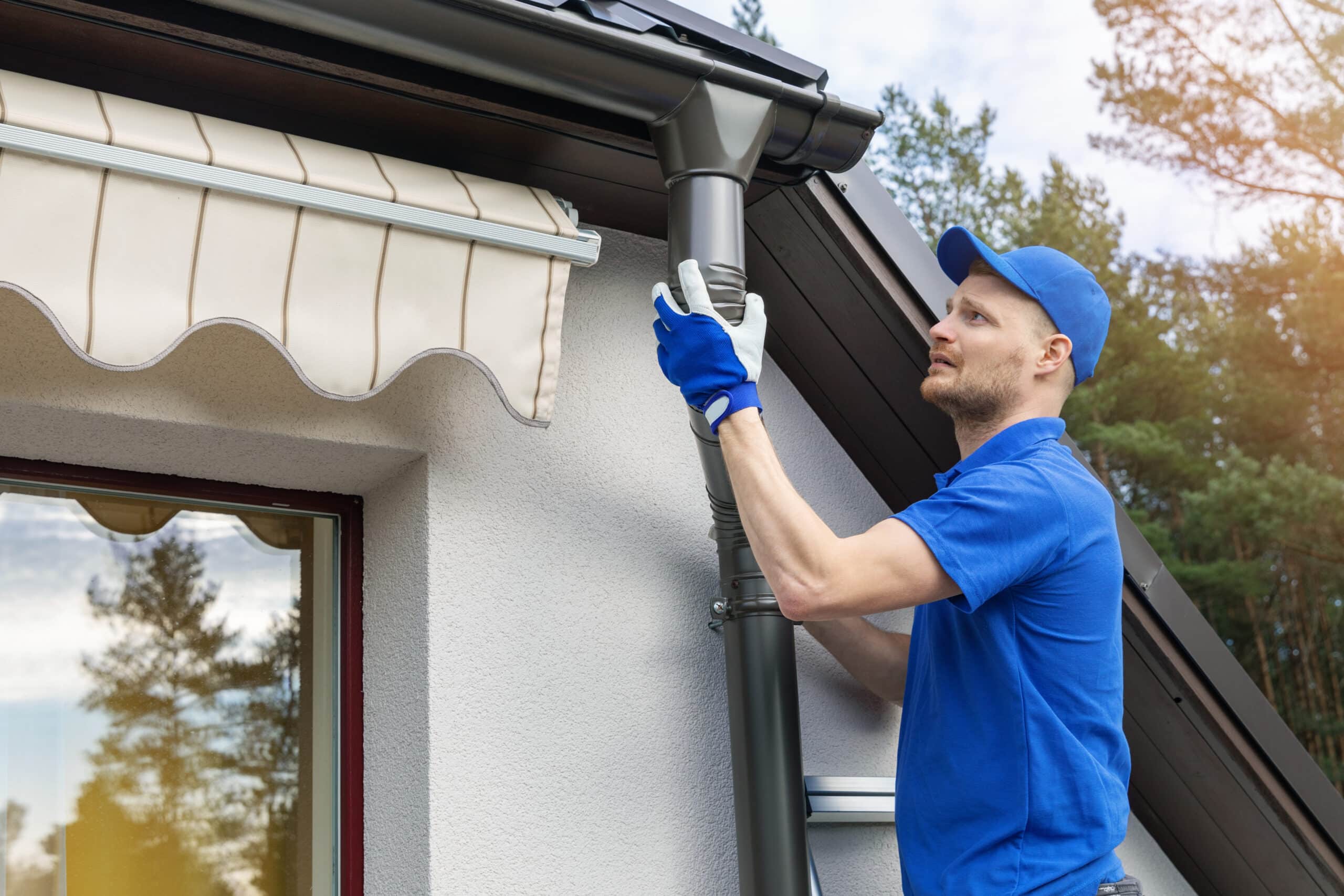 Person Installing Gutters
