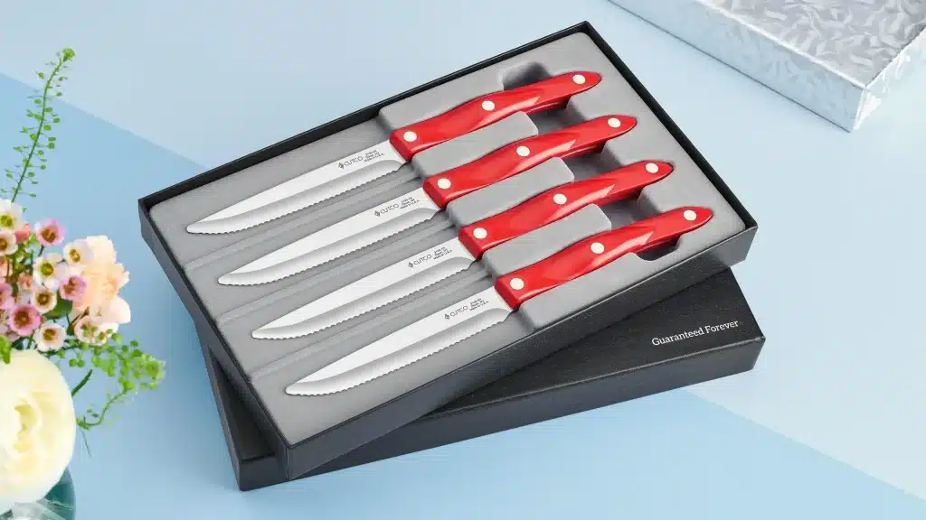 cutco steak knife set with red handles in a gift box